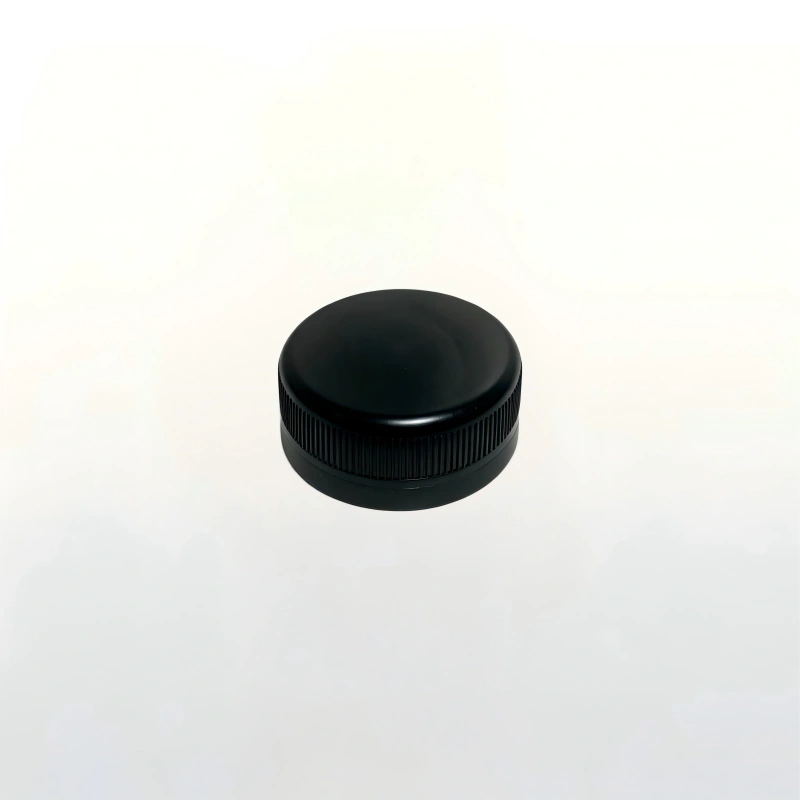 Square clear glass dairy beverage bottle fitted with black plastic screw cap
