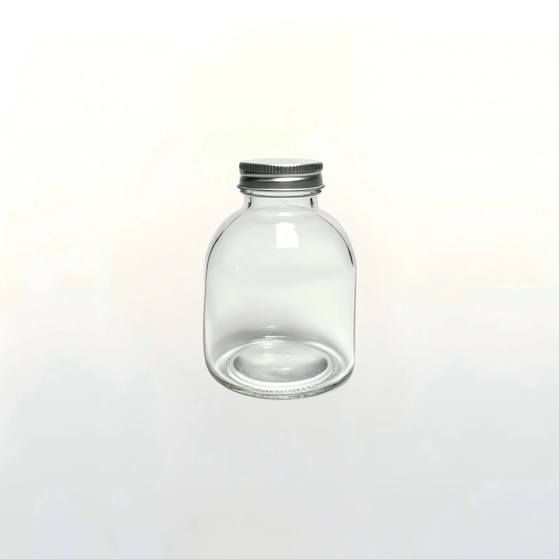 250ml clear bulbous round glass juice bottle with silver metal screw cap