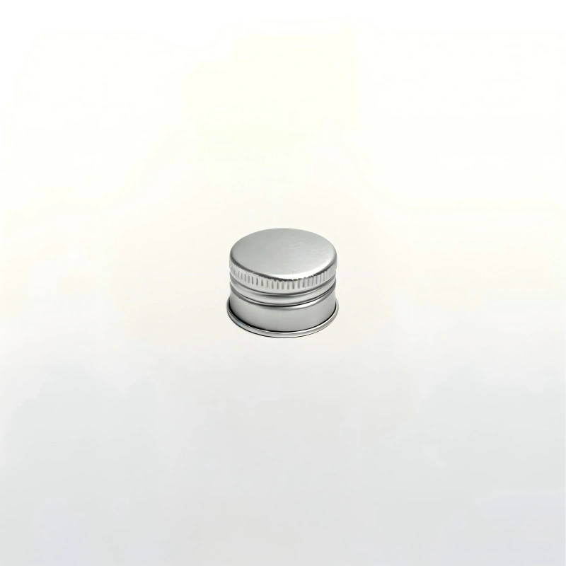 Silver aluminum screw cap for glass liquor bottle, ribbed side for easy twisting