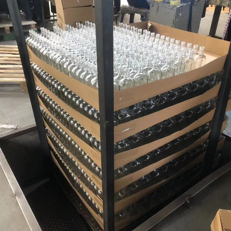 Glass bottles packed into export cartons with paper divider boards for anti‑collision protection