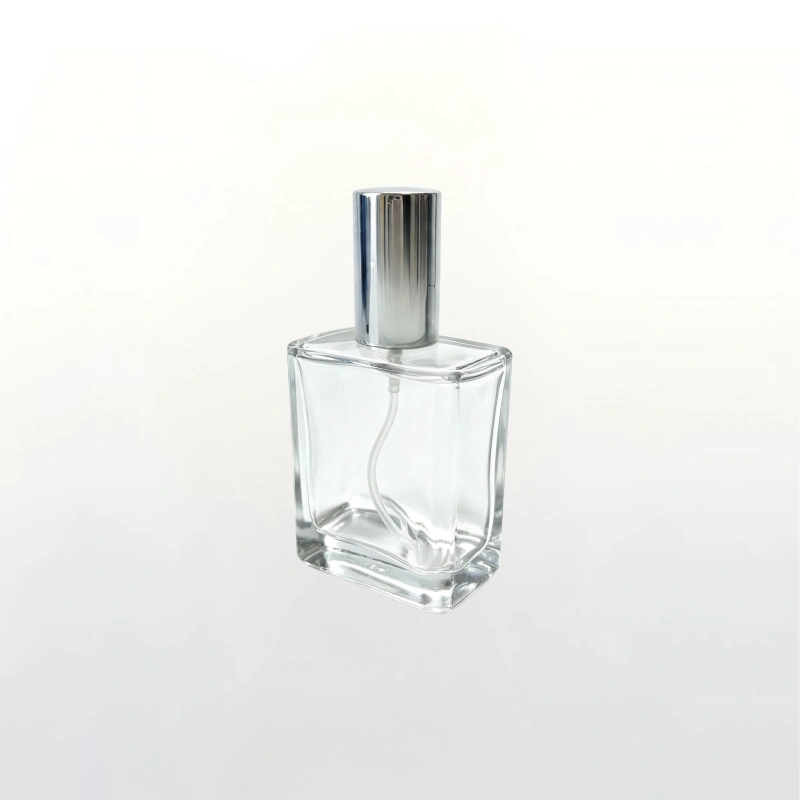Luxury square thick base clear glass perfume bottle with shiny silver cylindrical aluminum fine mist spray cap, empty refillable fragrance packaging bottle for indie cosmetic brands