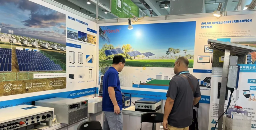 Technical specialist explaining solar water pump features to interested buyers at trade show