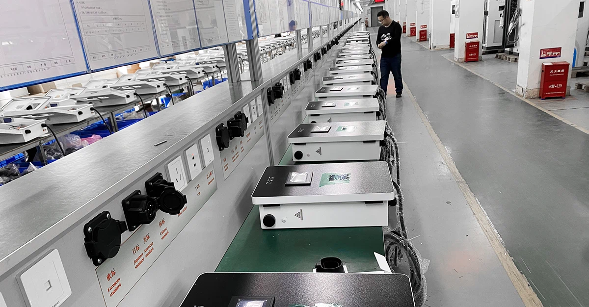 EV charger production workshop, manufacturing line for electric vehicle charging stations undergoing assembly and testing